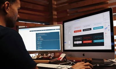 Man working on Web Design with two screens