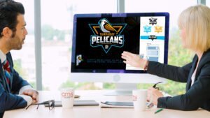 Business man showing client Tampa Bay Pelicans logo on computer
